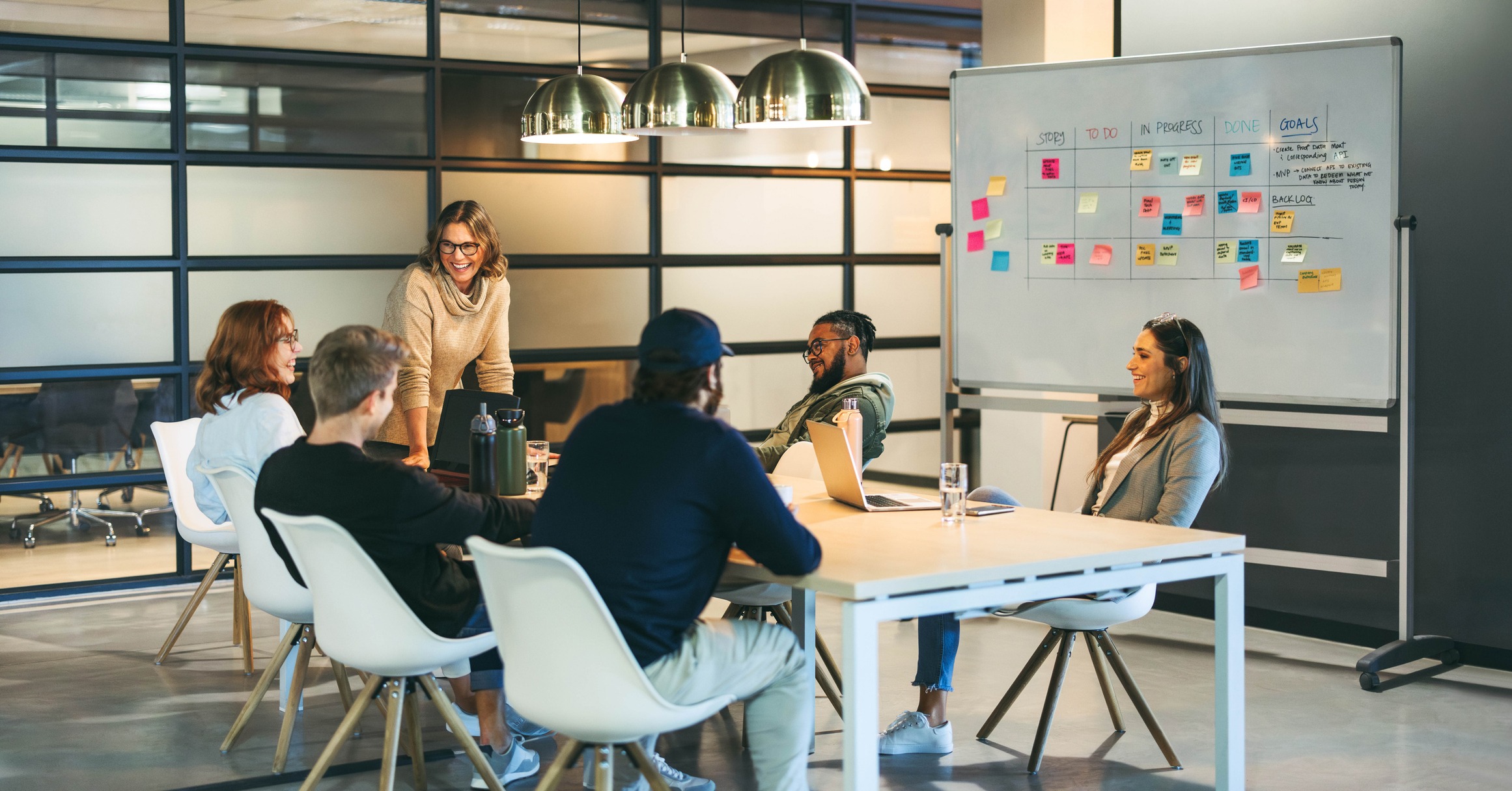 Staff augmentation team planning workflow on whiteboard in office