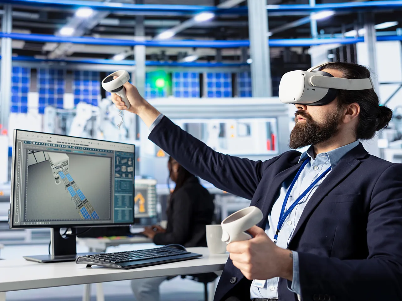 Virtual reality development specialist testing an industrial VR simulation with a headset and controllers